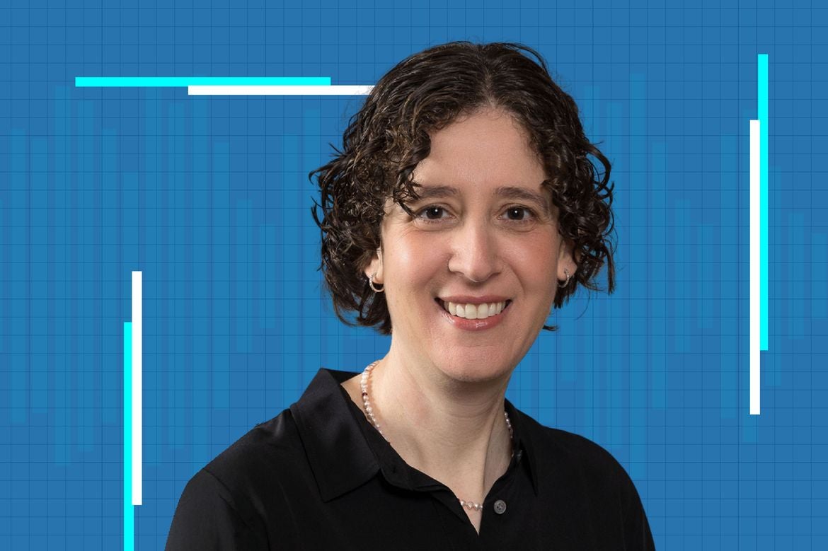 Elissa Hallem in a black shirt against a blue grid background