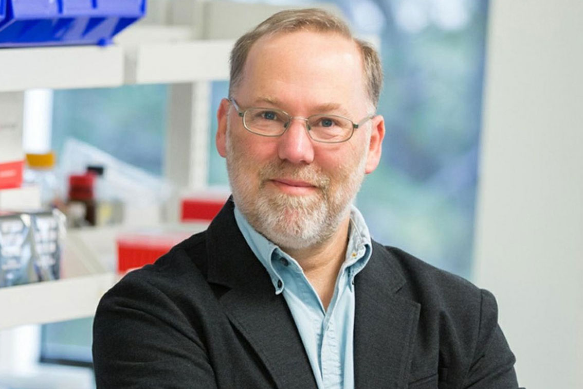 Dr. Fred Ramsdell standing in front of a lab.