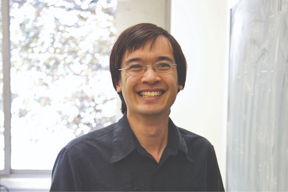 UCLA mathematician and Fields Medal winner Terence Tao smiling near a chalkboard